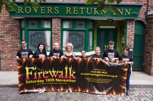 Sue Nichols on the Coronoation Street cobbles supporting the Firewalk