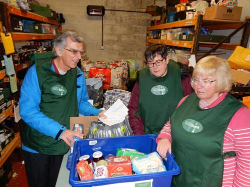 Volunteers at Towcester Food Bank read children’s letters during a break.