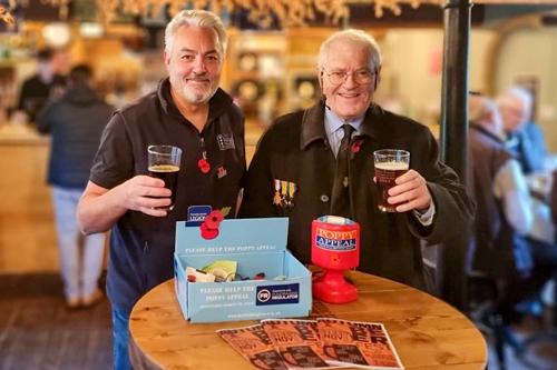 Brewery Director, John Evans, raising a glass with David Reed, from the Towcester branch of The Royal British Legion