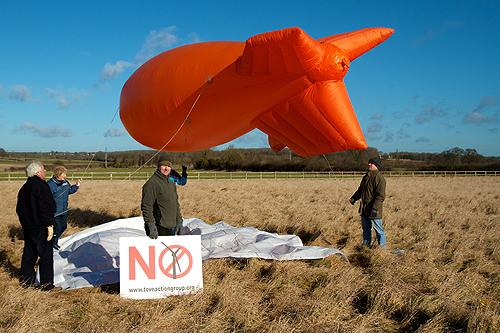 Members of Tove Action Group (TAG) ready their blimp to fly in the Tove Valley, in the back ground Stoke Park Pavillions.