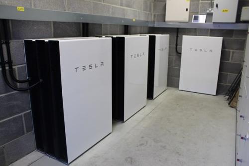 Several power banks for electric car charging with the Tesla logo branded on their fronts