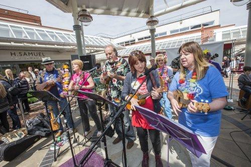Love Wirral Festival at the Pyramids Shopping Centre, Birkenhead. Wirral Ukulele Orchestra perform in front of the crowds