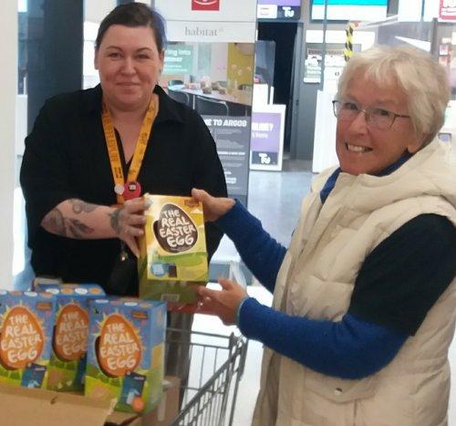Lucy Edmonds receives Food Bank donation from Irene Hilton-Ward, Neston Fairtrade Group.