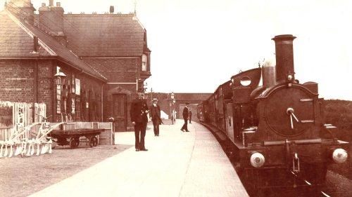 Neston South Station, now Station Road, with Mellock Lane bridge in the background.