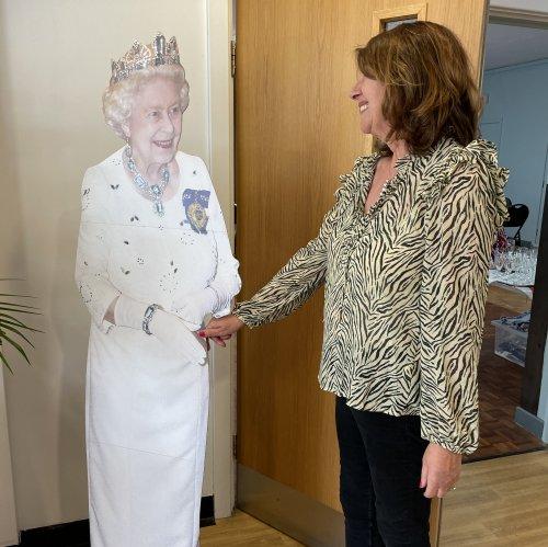 Our secretary meets Her Majesty.